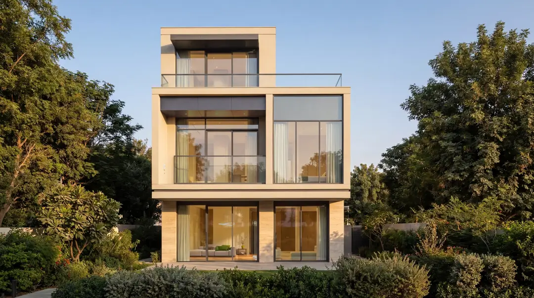 Dusk render of The Terraces townhouse row, warm light in the double-height windows